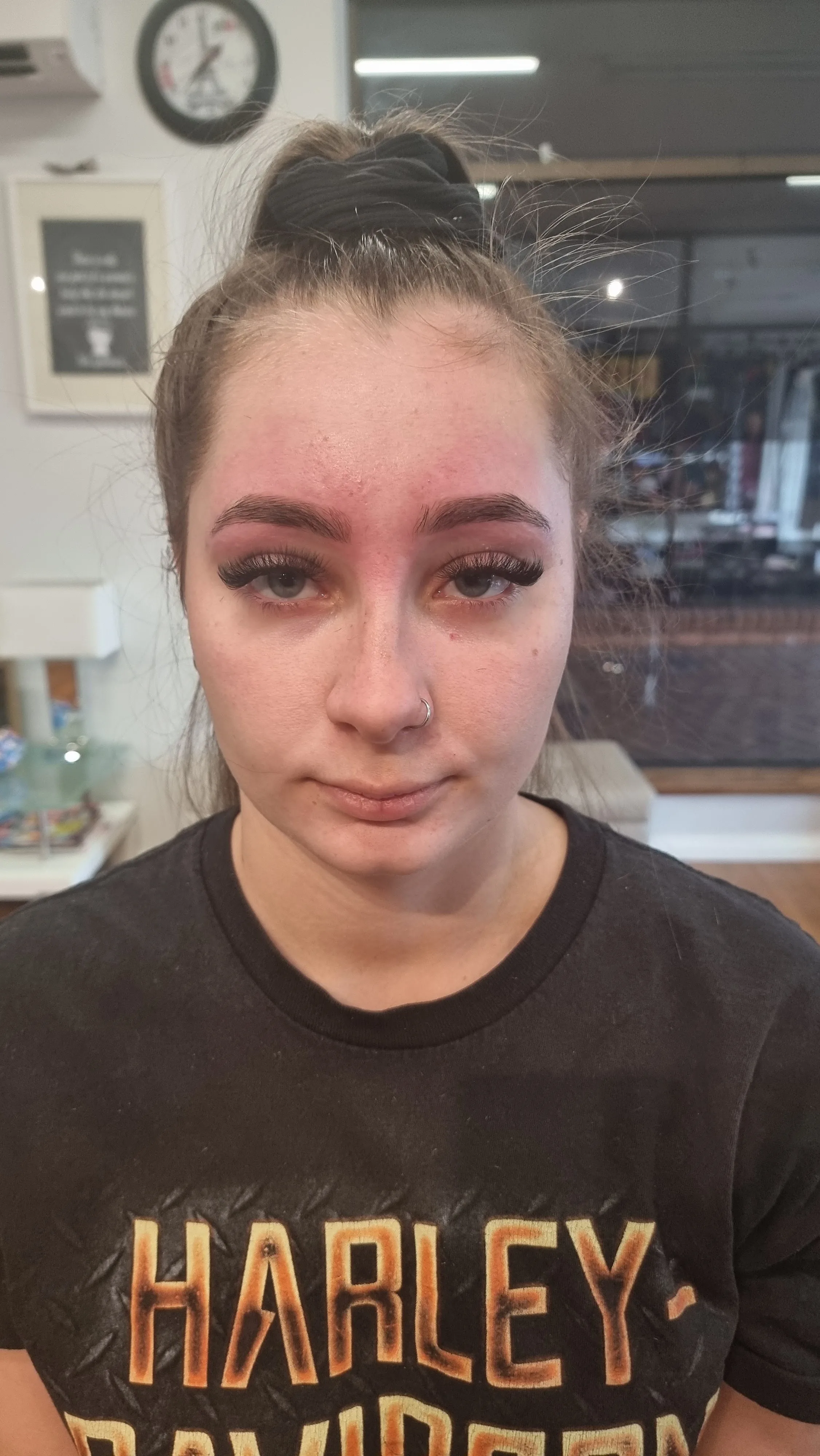 Freshly threaded and defined brows and lashes, close portrait